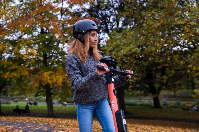 woman riding Voi scooter in Ireland