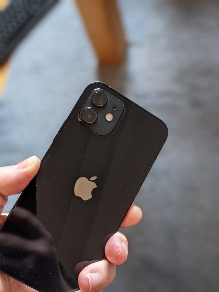 black iPhone 12 in hand