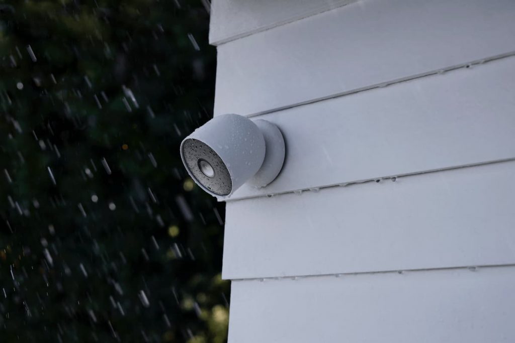 a google nest cam in the rain, fixed to a wall