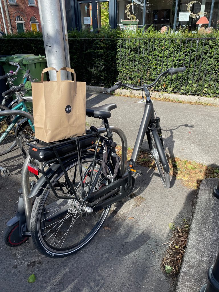 ebike parked outside cafe with food 