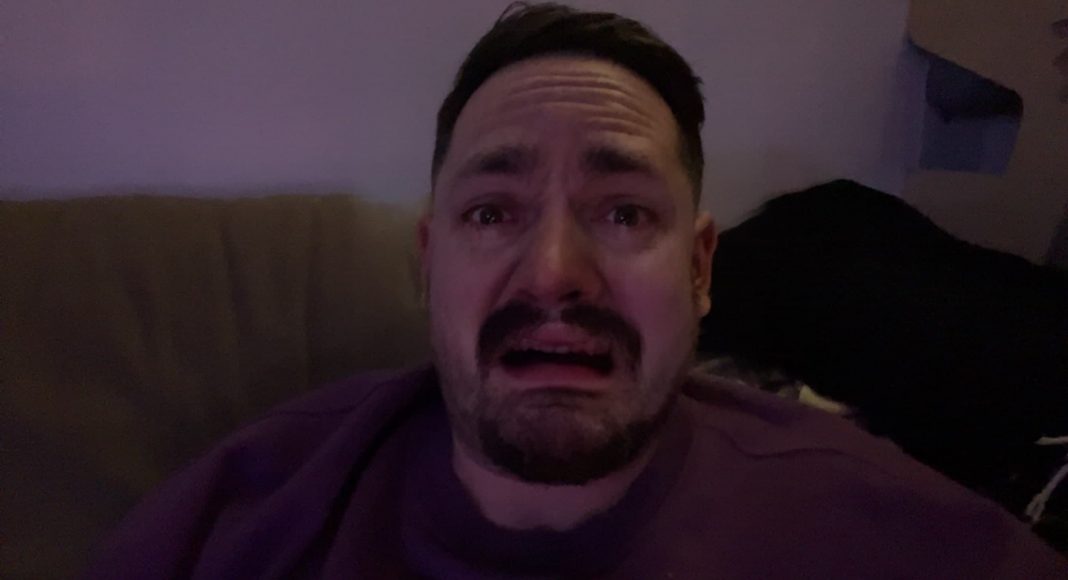 man using tiktok sad face filter