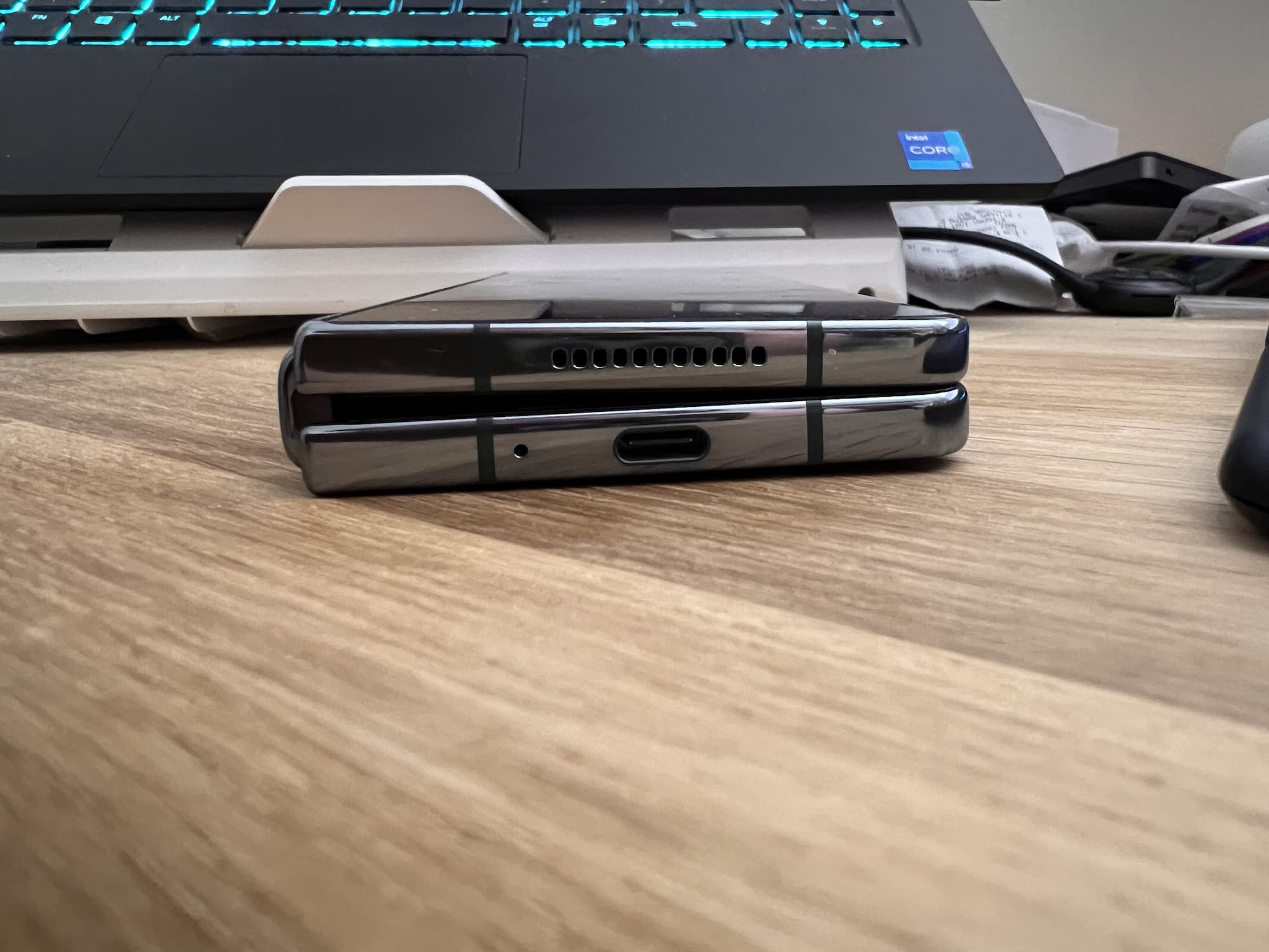 Picture of the Samsung Galaxy Fold 4 on a table, closed, showing the prominent gap in the design to the left.