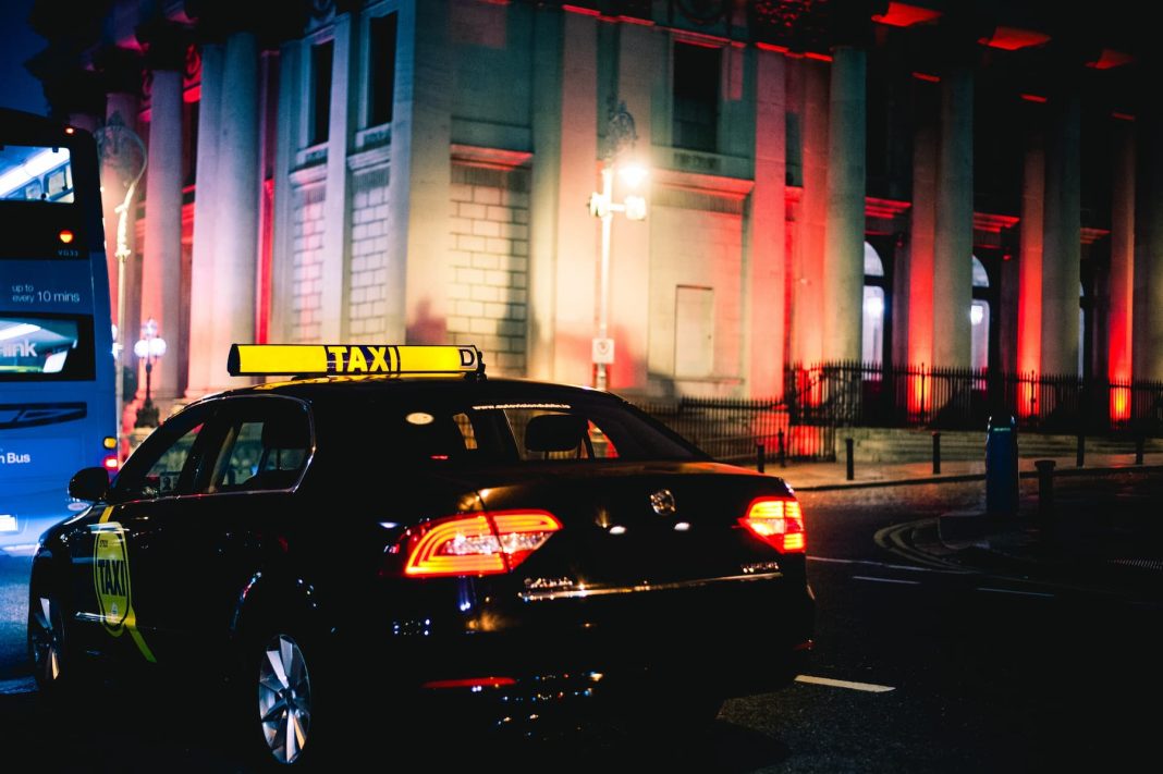 a taxi driving past city hall in dublin